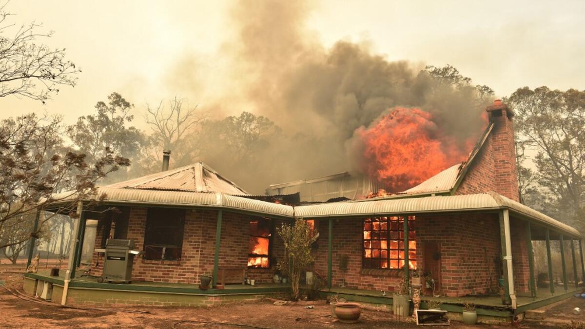 A property burns from bushfires in Balmoral, 150 kilometres southwest of Sydney on December 19, 2019. A state of emergency was declared in Australia's most populated region on December 19, as a record heat wave fanned unprecedented bushfires. PETER PARKS / AFP