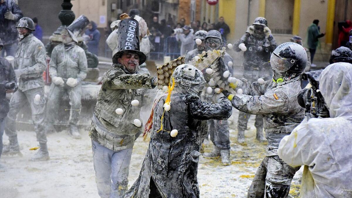 The Els Enfarinats festival takes place every year in Spain and sees two groups of residents cover each other and the entire town white with egg and flour (Twitter)