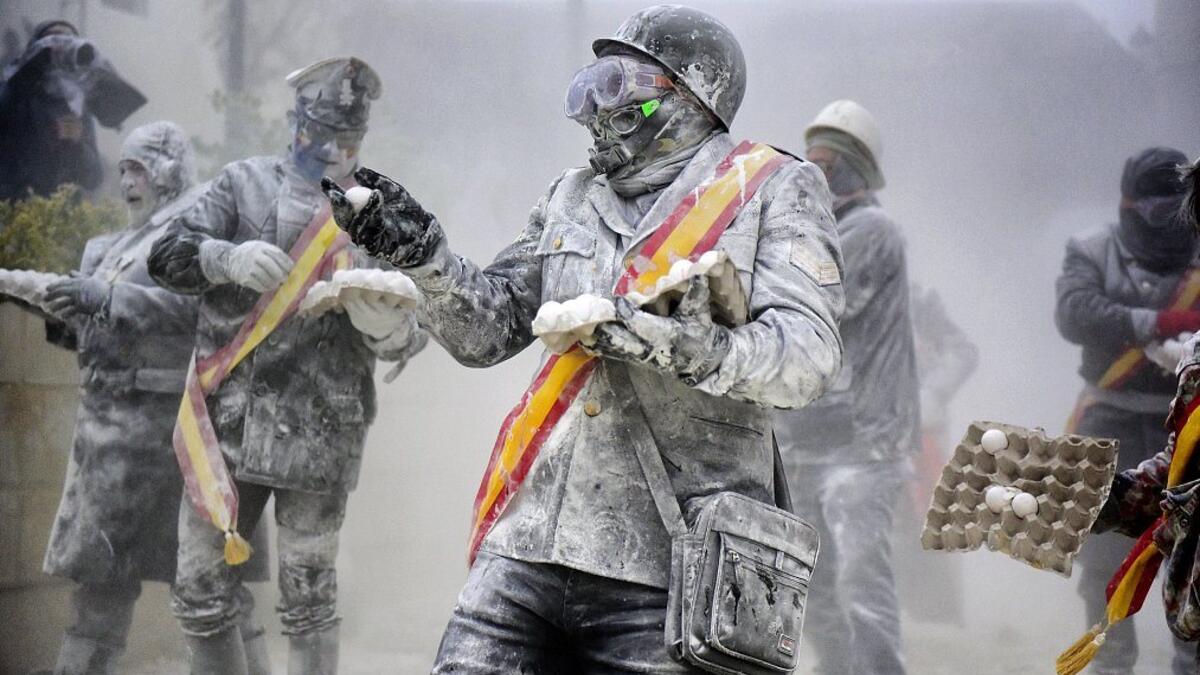 The Els Enfarinats festival takes place every year in Spain and sees two groups of residents cover each other and the entire town white with egg and flour (Twitter)