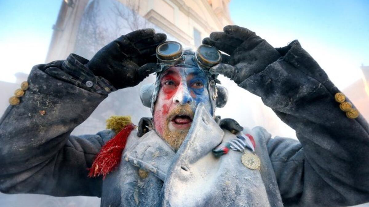 A resident takes part in a flour and egg battle during the 'Els enfarinats' festival in the village of Ibi, Alicante, eastern Spain (Twitter)