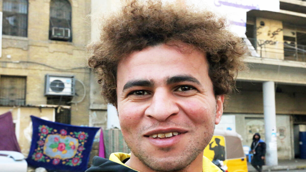 An Iraqi anti-government protestor poses with a distinct hairstyle at Tahrir Square in central Baghdad on December 23, 2019. Since the start of Iraq's anti-government protests on October 1, one thing strikes the eye perhaps above all else -- the unbridled hairstyles young men sport. High quiffs, tight fades and loads of attitude -- it is quite the male beauty pageant. SABAH ARAR / AFP