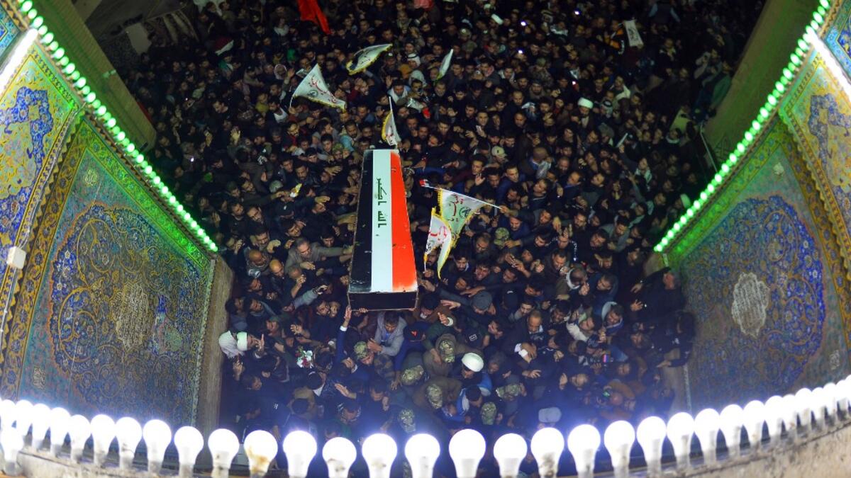 Mourners carry the coffin of slain Iraqi paramilitary chief Abu Mahdi al-Muhandis, toward the Imam Ali Shrine, in the shrine city of Najaf in central Iraq during a funeral procession on January 4, 2020. Thousands of Iraqis chanted "Death to America" today as they mourned the deaths of al-Muhandis and Soleimani, who were killed in a US drone attack that sparked fears of a regional proxy war between Washington and Tehran. Haidar HAMDANI / AFP