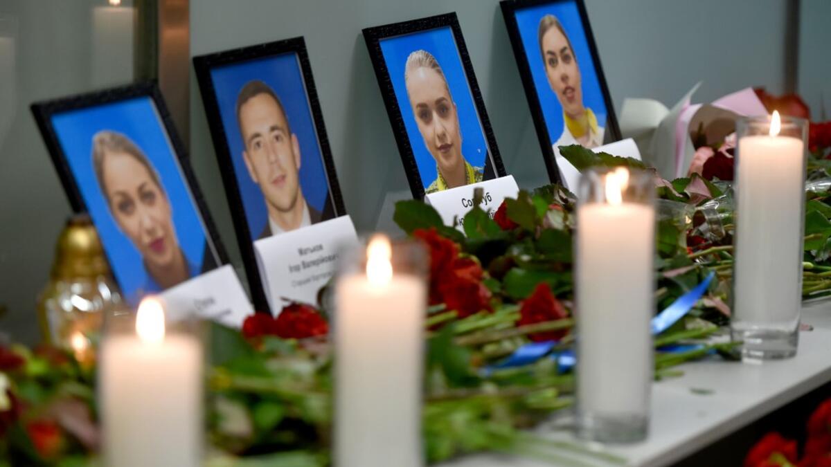 Portraits of the victims of the Ukraine International Airlines Boeing 737-800 crash in the Iranian capital Tehran, are seen at a memorial at the Boryspil airport outside Kiev on January 8, 2020. A Ukrainian airliner crashed shortly after take-off from Tehran Wednesday killing all 176 people on board, in a disaster striking a region rattled by heightened military tensions. Sergei SUPINSKY / AFP