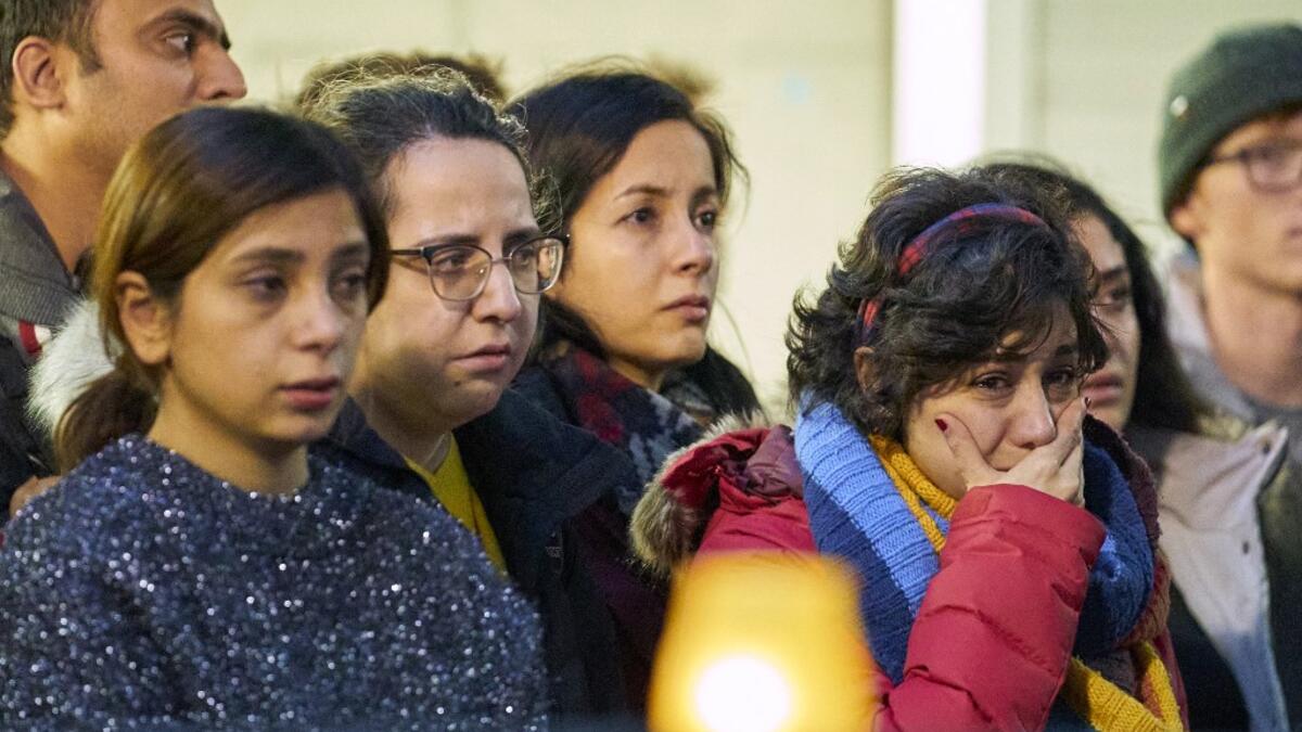 A woman weeps during a memorial service at Western University in London, Ontario on January 8, 2020 for the four graduate students who were killed in a plane crash in Iran. A Ukrainian airliner crashed shortly after take-off from Tehran on January 8 killing all 176 people on board, in a disaster striking a region rattled by heightened military tensions. Geoff Robins / AFP