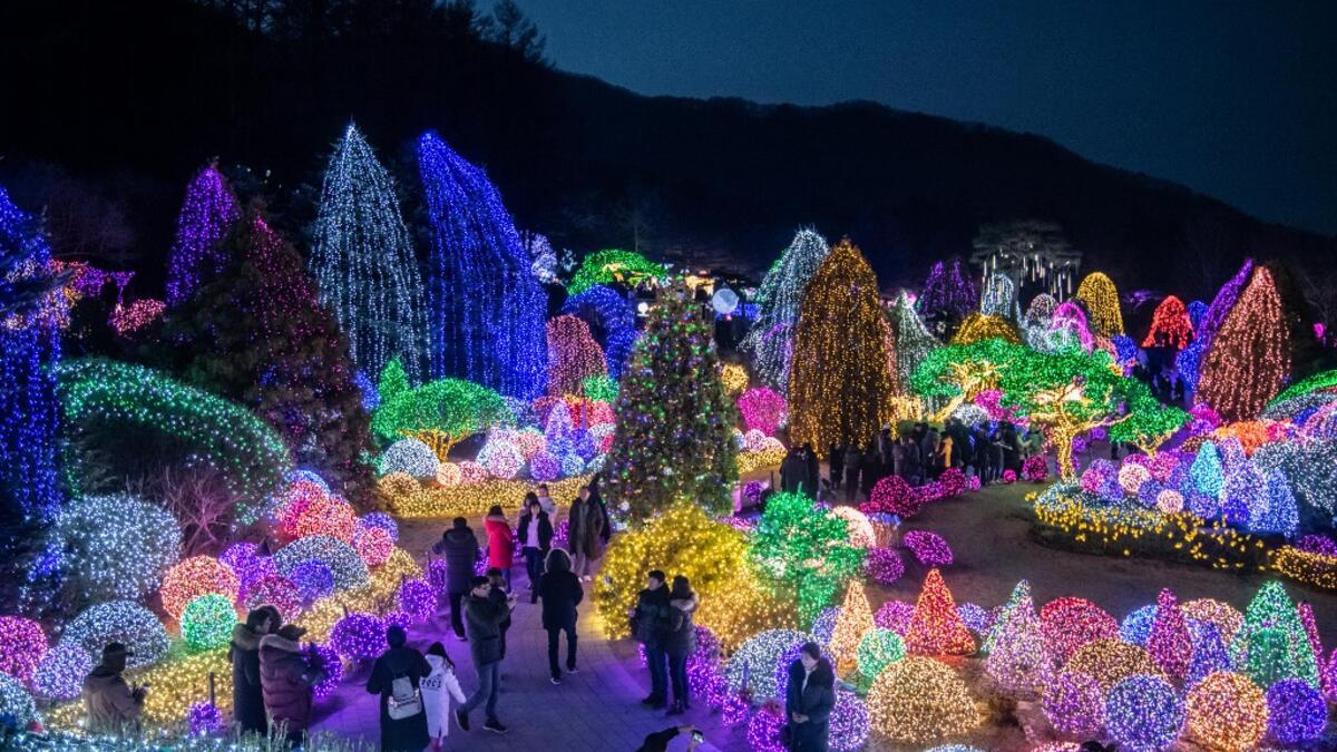 In a photo taken on January 11, 2020 visitors look at an annual light display at the 'Garden on Morning Calm', near Gapyeong, east of Seoul. Ed JONES / AFP