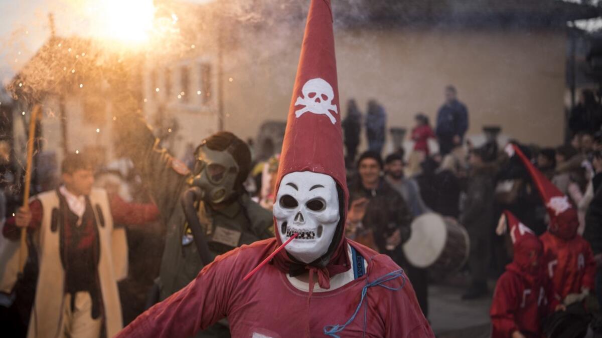 Masked revellers take part in a carnival procession through the south-western North Macedonian village of Vevcani, on January 13, 2020. The Vevcani carnival is 1.400 years old and is held every year on the eve of the feast of Saint Basil (January 14), which also marks the beginning of the New Year according to the Julian calendar, observed by the Macedonian Orthodox Church. Robert ATANASOVSKI / AFP