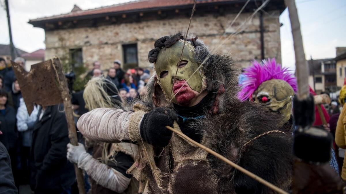Masked revellers take part in a carnival procession through the south-western North Macedonian village of Vevcani, on January 13, 2020. The Vevcani carnival is 1.400 years old and is held every year on the eve of the feast of Saint Basil (January 14), which also marks the beginning of the New Year according to the Julian calendar, observed by the Macedonian Orthodox Church. Robert ATANASOVSKI / AFP