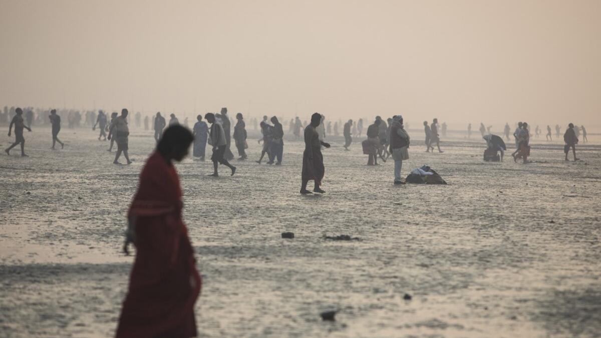 Hindu devotees gather to take a holy dip in the Bay of Bengal during the Gangasagar Mela, at Sagar Island, some 150 kilometres south of Kolkata on January 14, 2020. XAVIER GALIANA / AFP