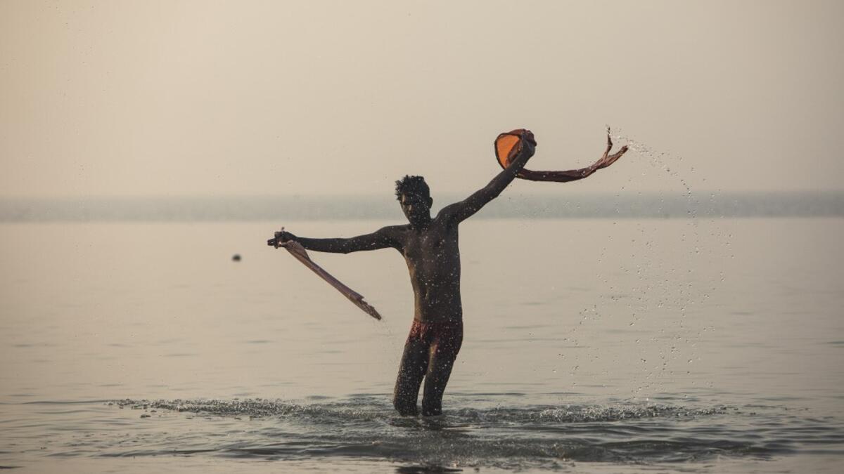 A Hindu devotee takes a holy dip in the Bay of Bengal during the Gangasagar Mela, at Sagar Island, some 150 kilometres south of Kolkata on January 14, 2020. Xavier GALIANA / AFP