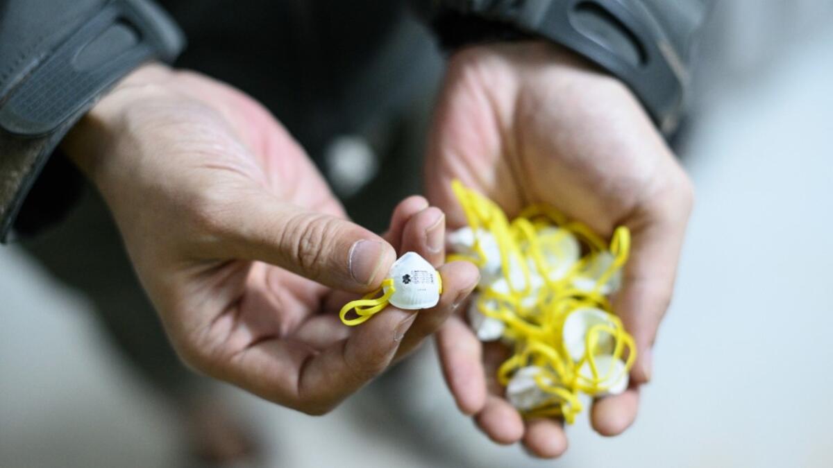 This picture taken on January 14, 2020 shows 1:6 scale face masks for action figures depicting characters involved in the Hong Kong protests, in Hong Kong. Intricately detailed Hong Kong protester figurines have become the latest must-have collectables as toy stores recreate the pro-democracy movement's street battles with police in their shop displays.  Philip FONG / AFP