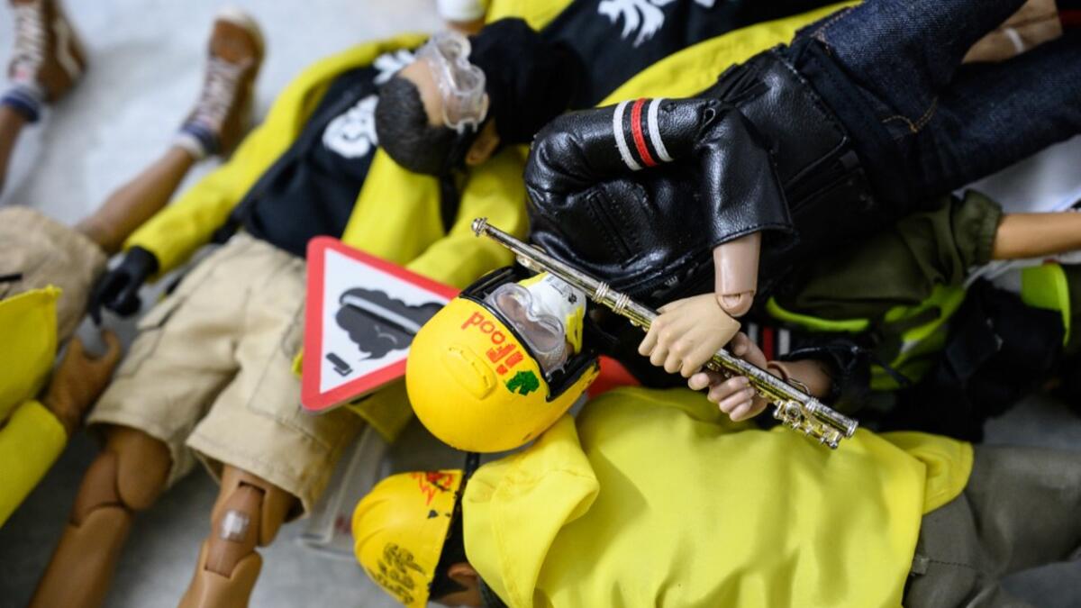 This picture taken on January 14, 2020 shows 1:6 scale action figures depicting characters involved in the Hong Kong protests, in Hong Kong. Intricately detailed Hong Kong protester figurines have become the latest must-have collectables as toy stores recreate the pro-democracy movement's street battles with police in their shop displays.  Philip FONG / AFP