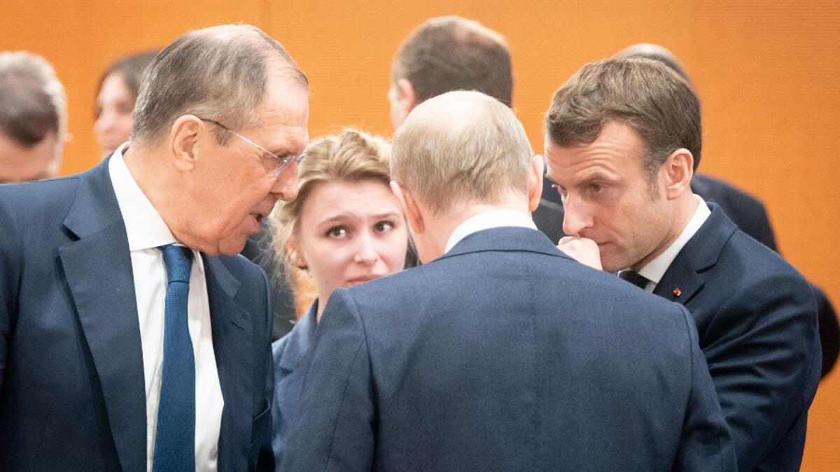 (L-R) Acting Russian Foreign Minister Sergei Lavrov, Russian President Vladimir Putin and France's President Emmanuel Macron talk at the start of a Peace summit on Libya at the Chancellery in Berlin, on January 19, 2020. Kay Nietfeld / POOL / AFP