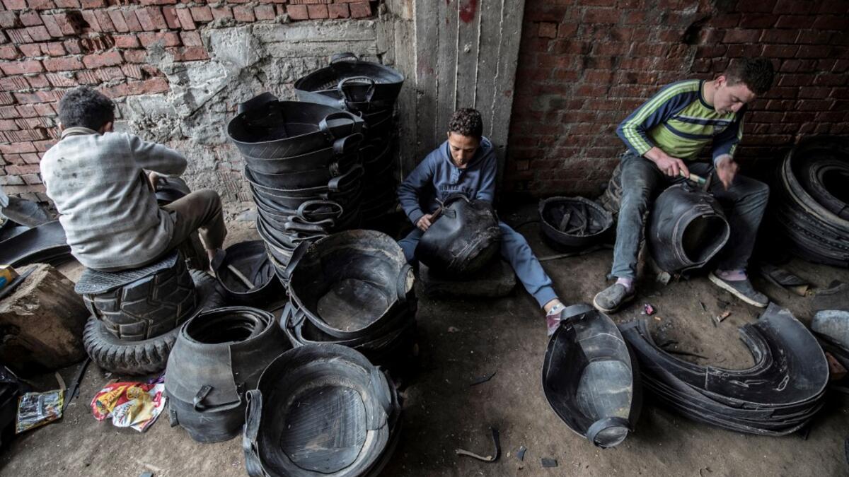 Labourers create rubber baskets from recycled tyre components at a rubber recycling workshop in the village of Mit al-Harun in Egypt's central Nile delta Gharbia Governorate, about 70 kilometres (43 miles) north of the capital, on January 14, 2020. Khaled DESOUKI / AFP