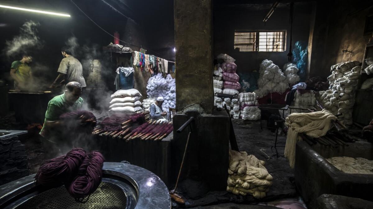 Salama and his relatives lay out the long, flowing threads, which will be used for everything from handmade shoes to rugs and drapes, and dip them in huge, piping-hot colour baths -- no gloves or masks protecting them from the dyes and chemical fumes. The workshop in Islamic Cairo has been going strong for over a hundred years. Khaled DESOUKI / AFP