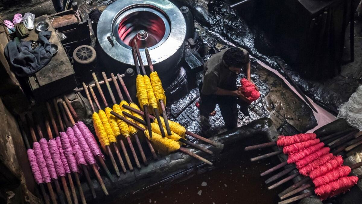 Salama and his relatives lay out the long, flowing threads, which will be used for everything from handmade shoes to rugs and drapes, and dip them in huge, piping-hot colour baths -- no gloves or masks protecting them from the dyes and chemical fumes. The workshop in Islamic Cairo has been going strong for over a hundred years. Khaled DESOUKI / AFP