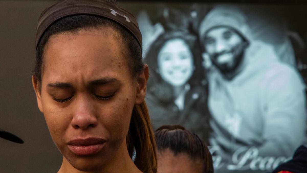 A woman cries in front of a makeshift memorial for former NBA and Los Angeles Lakers player Kobe Bryant and his daughter Gianna Bryant, who were killed with seven others in a helicopter crash on January 26, at LA Live plaza in front of Staples Center in Los Angeles on January 27, 2020. Federal investigators sifted through the wreckage of the helicopter crash that killed basketball legend Kobe Bryant and eight other people, hoping to find clues to what caused the accident that stunned the world. Apu GOMES /