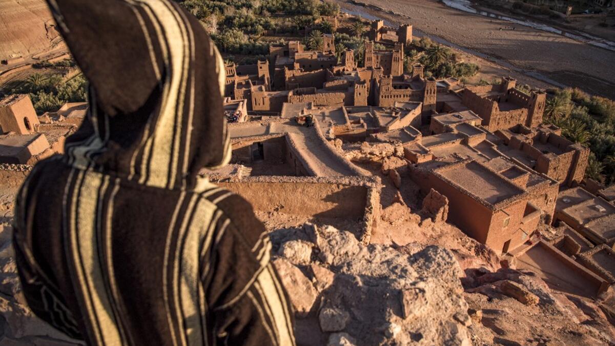 A man stands overlooking the Kasbah (ancient fortress) of Ait-Ben-Haddou, where scenes depicting the fictional city of Yunkai from the hit HBO television series "Game of Thrones" were filmed, about 32 kilometres northwest of the city of Ouarzazate south of Morocco's High Atlas mountains on January 27, 2020.FADEL SENNA / AFP