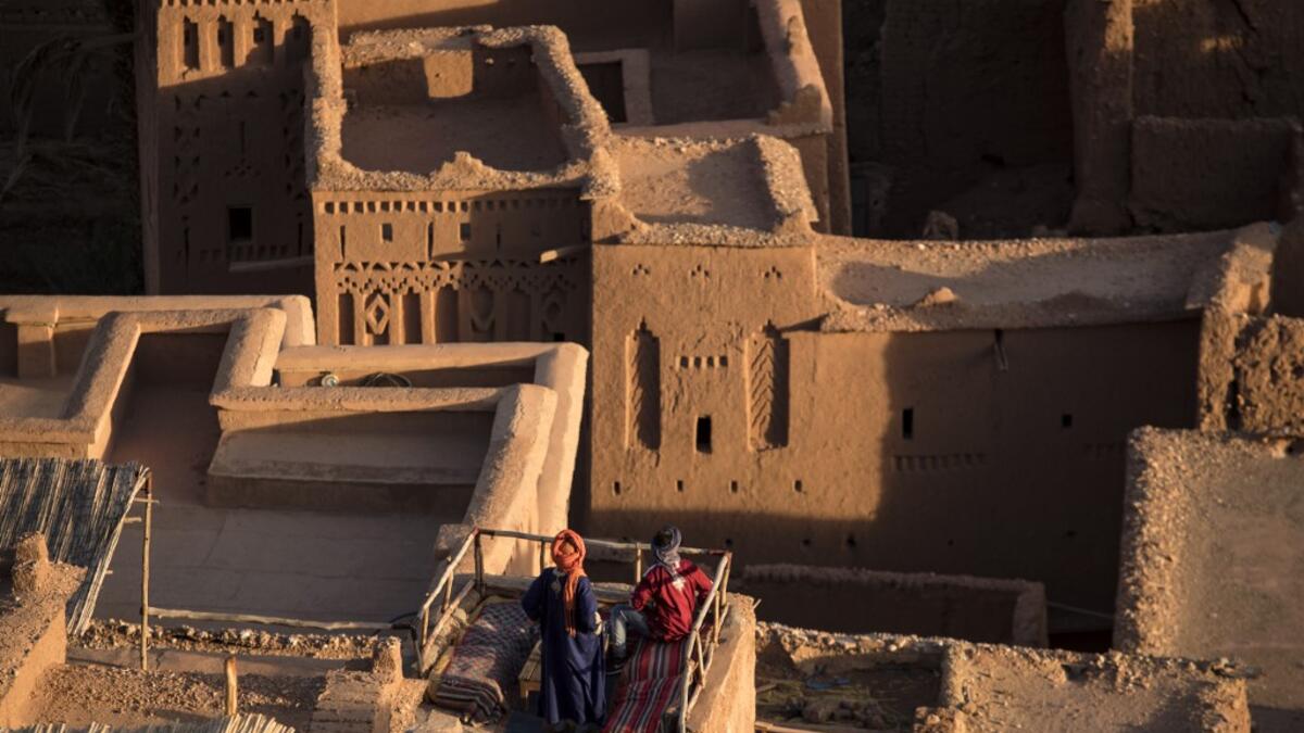 Men stand atop the Kasbah (ancient fortress) of Ait-Ben-Haddou, where scenes depicting the fictional city of Yunkai from the hit HBO television series "Game of Thrones" were filmed, about 32 kilometres northwest of the city of Ouarzazate south of Morocco's High Atlas mountains on January 27, 2020. FADEL SENNA / AFP