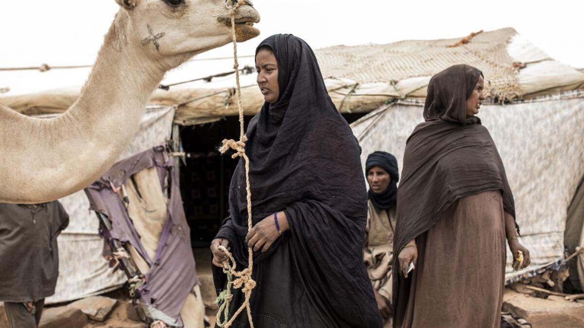 A family from the small Nemadi(hunters) tribe in Eastern Mauritania is seen at outside their families tent in the Loudeyatt Nemadi Camp on January 23, 2020. In the arid West African country of Mauritania, the way of life of the traditional group of hunters known as the Nemadi is slowly disappearing. JOHN WESSELS / AFP
