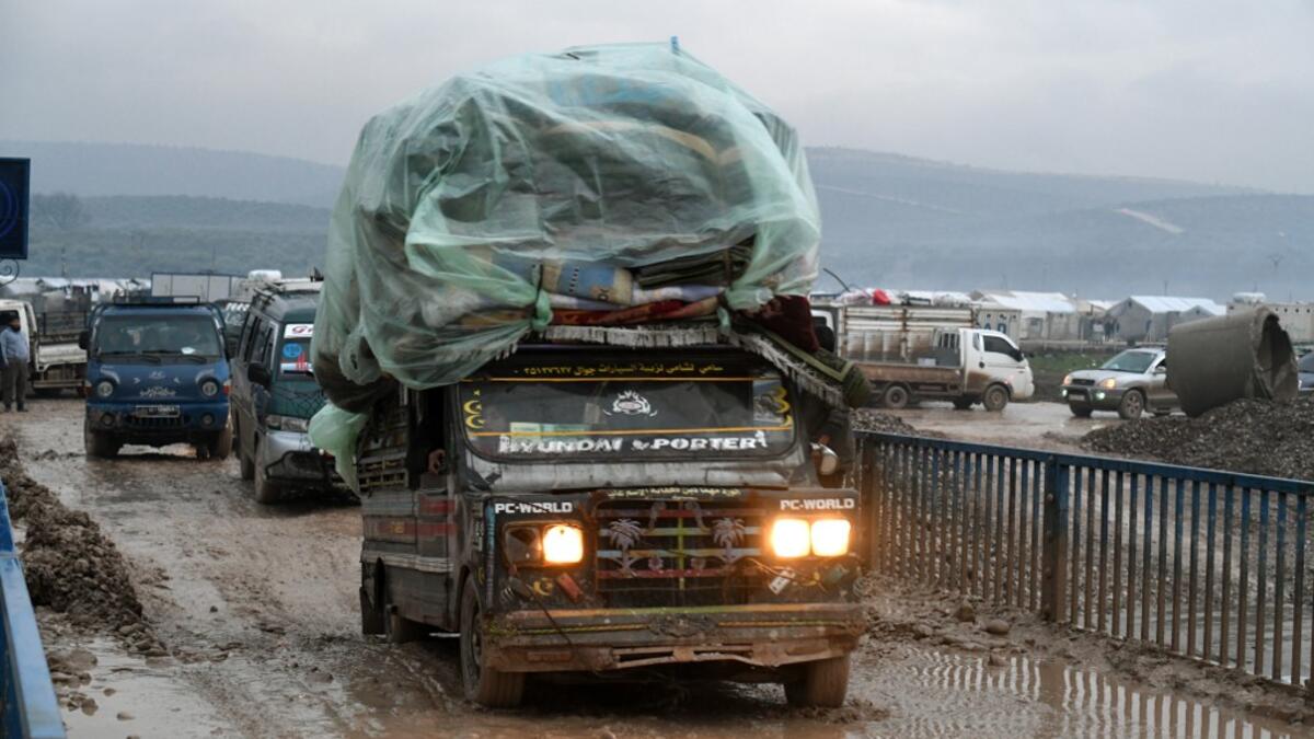 Syrians displaced from the south of Idlib province travelling in vehicles loaded with furniture and other belongings and fleeing from advancing government forces arrive at a camp for the internally displaced near Dayr Ballut, near the Turkish border in the rebel-held part of Aleppo province in the country's northwest on February 4, 2020. Rami al SAYED / AFP