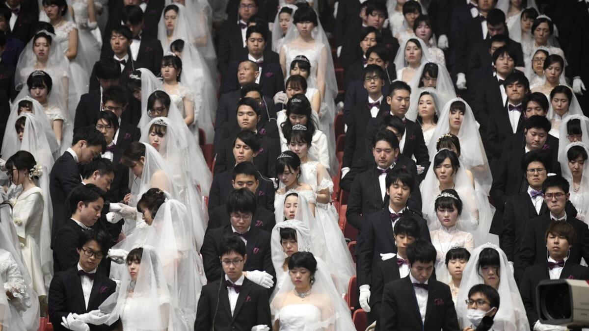 Couples attend a mass wedding ceremony organised by the Unification Church at Cheongshim Peace World Center in Gapyeong on February 7, 2020. Thousands of Unification Church couples married at a mass wedding to mark the eighth anniversary of the death of founder and self-proclaimed messiah Sun Myung Moon. Jung Yeon-je / AFP