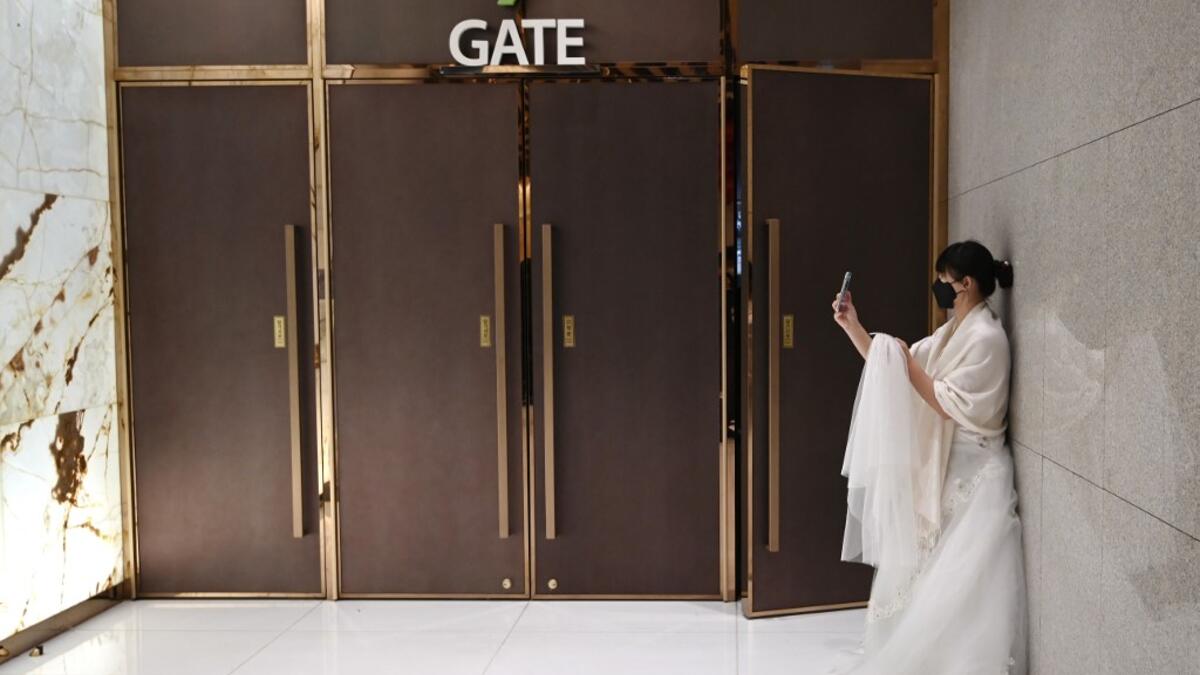 A bride wearing a protective face mask attends a mass wedding ceremony organised by the Unification Church at Cheongshim Peace World Center in Gapyeong on February 7, 2020. South Korea has confirmed 24 cases of the SARS-like virus so far and placed nearly 260 people in quarantine for detailed checks amid growing public alarm. Jung Yeon-je / AFP