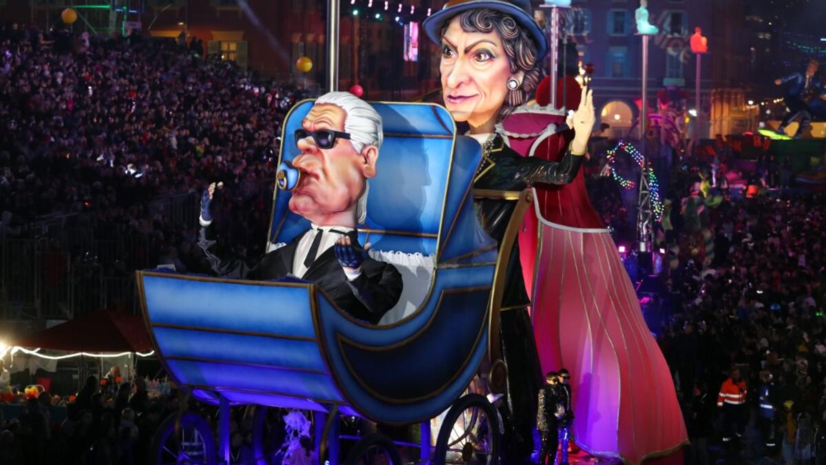 Giant figures depicting German fashion designer Karl Lagerfeld and French fashion designer Coco Chanel are seen during the 136th Nice Carnival parade in Nice, southeastern France, on February 15, 2020. The Carnival takes place until February 29, 2020 on the theme 'King of Fashion'. VALERY HACHE / AFP