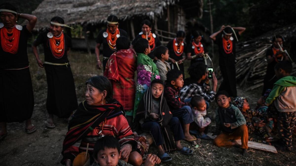 This photo taken on February 7, 2020 shows villagers watching the end of an overnight ceremony to bless the harvest by Naga tribeswomen in Satpalaw Shaung village, Lahe township in Myanmar's Sagaing region. A haunting refrain pierces the night as the tribeswomen of the Gongwang Bonyo, among the most isolated people in Myanmar, dance around a campfire to bless the harvest ahead. Ye Aung THU / AFP
