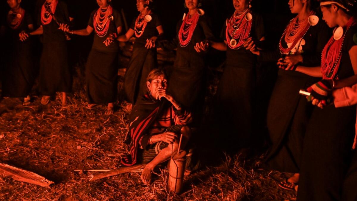 This photo taken on February 6, 2020 shows Naga tribeswomen taking part in an overnight ceremony to bless the harvest in Satpalaw Shaung village, Lahe township in Myanmar's Sagaing region. A haunting refrain pierces the night as the tribeswomen of the Gongwang Bonyo, among the most isolated people in Myanmar, dance around a campfire to bless the harvest ahead. Ye Aung THU / AFP