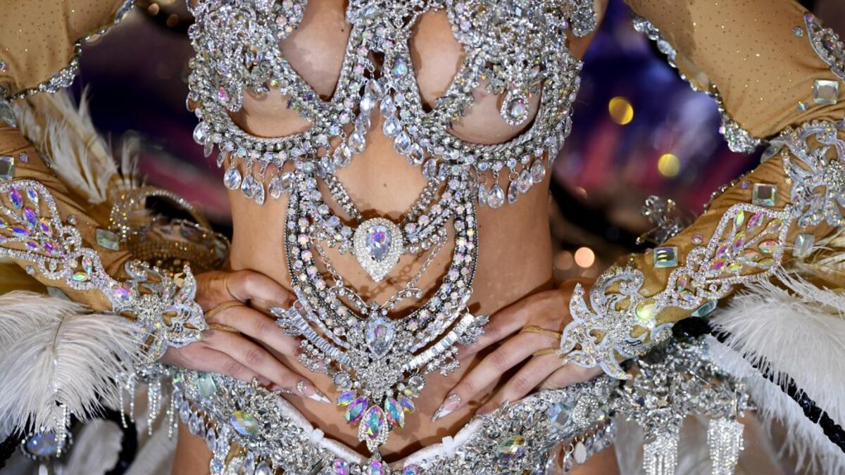A participant prepares backstage before presenting her outfit during the Queen of the Carnival pageant contest in Santa Cruz de Tenerife, on the Spanish Canary island of Tenerife, on February 19, 2020. Gabriel BOUYS / AFP