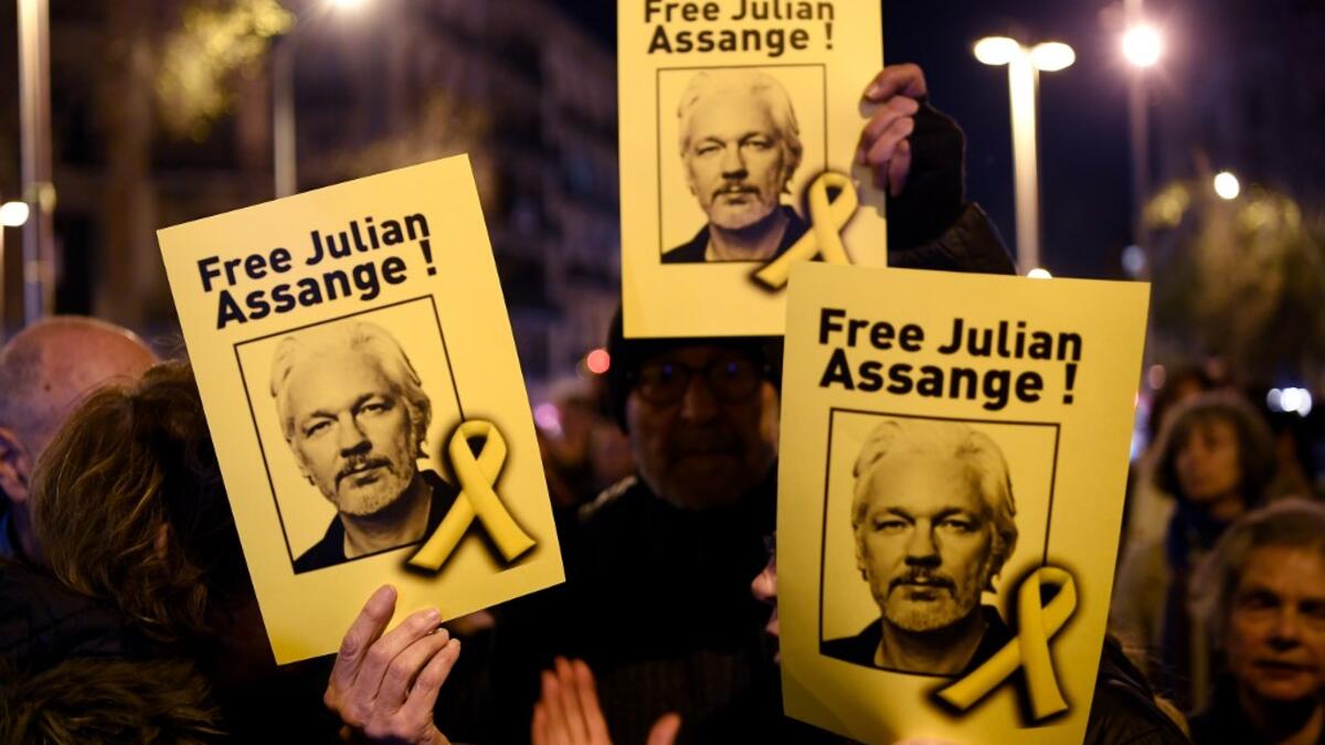 Demonstrators hold signs during a protest called by Catalan National Assembly (ANC) under the motto "Journalism is not a crime" to support WikiLeaks founder Julian Assange in Barcelona on February 24, 2020. A British court today starts hearing Washington's extradition request for WikiLeaks founder Julian Assange in a test case of media freedoms in the digital age and the global limits of US justice. LLUIS GENE / AFP