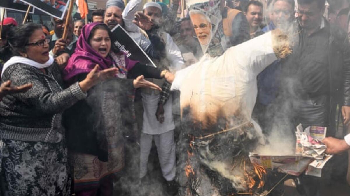 Congress party supporters in Amritsar burn an effigy of Narendra Modi during a demonstration to protest against the violence occurring in Delhi. Photograph: Narinder Nanu/AFP via Getty Images