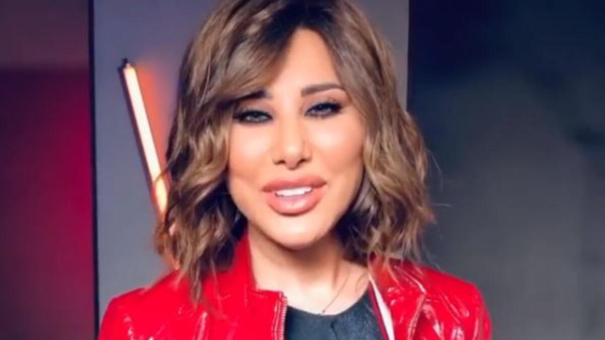 Najwa Karam threw greeting cards from an aircraft with the word "Lebnon is in our heart" greeting Lebanon and Lebanese