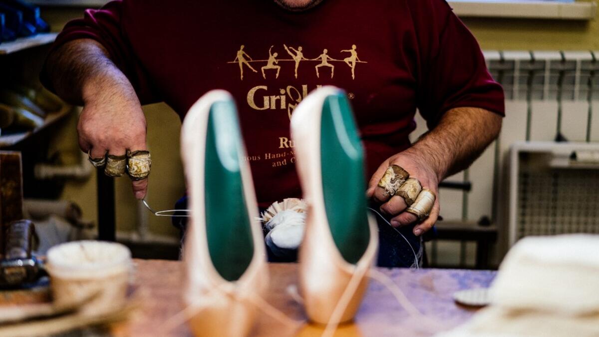 An employee of Grishko company produces pointe shoes in the company's Moscow workshop on February 25, 2020. Born in the chaos of the collapse of the Soviet Union, the Grishko family business has emerged among the top makers in the world of dance shoes, notably classic ballet pointe shoes, worn on the world's great stages. Dimitar DILKOFF / AFP