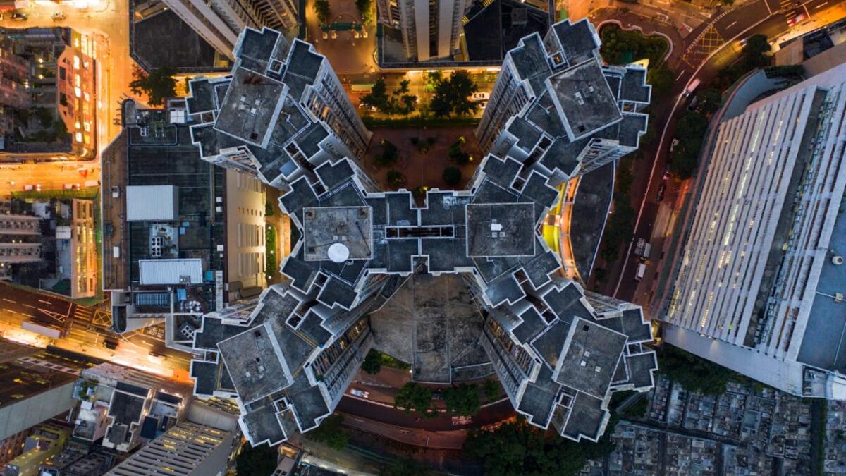This aerial photograph taken on May 15, 2019 shows a housing estate (C) in Hong Kong. DALE DE LA REY / AFP