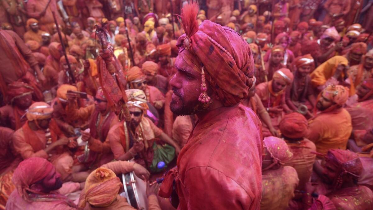 Hindu devotees celebrate Holi, the spring festival of colours, during a traditional gathering at a temple in Nandgaon village in Uttar Pradesh state on March 5, 2020. Holi is observed in India at the end of the winter season on the last full moon of the lunar month. Money SHARMA / AFP