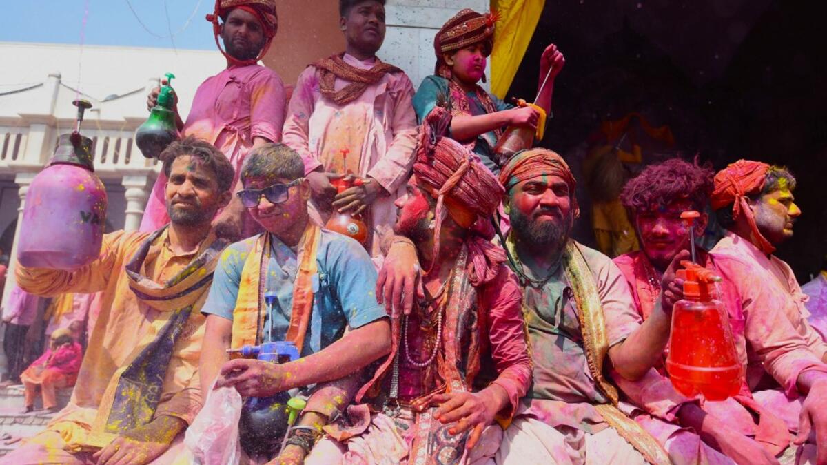 Hindu devotees celebrate Holi, the spring festival of colours, during a traditional gathering at a temple in Nandgaon village in Uttar Pradesh state on March 5, 2020. Holi is observed in India at the end of the winter season on the last full moon of the lunar month. Money SHARMA / AFP