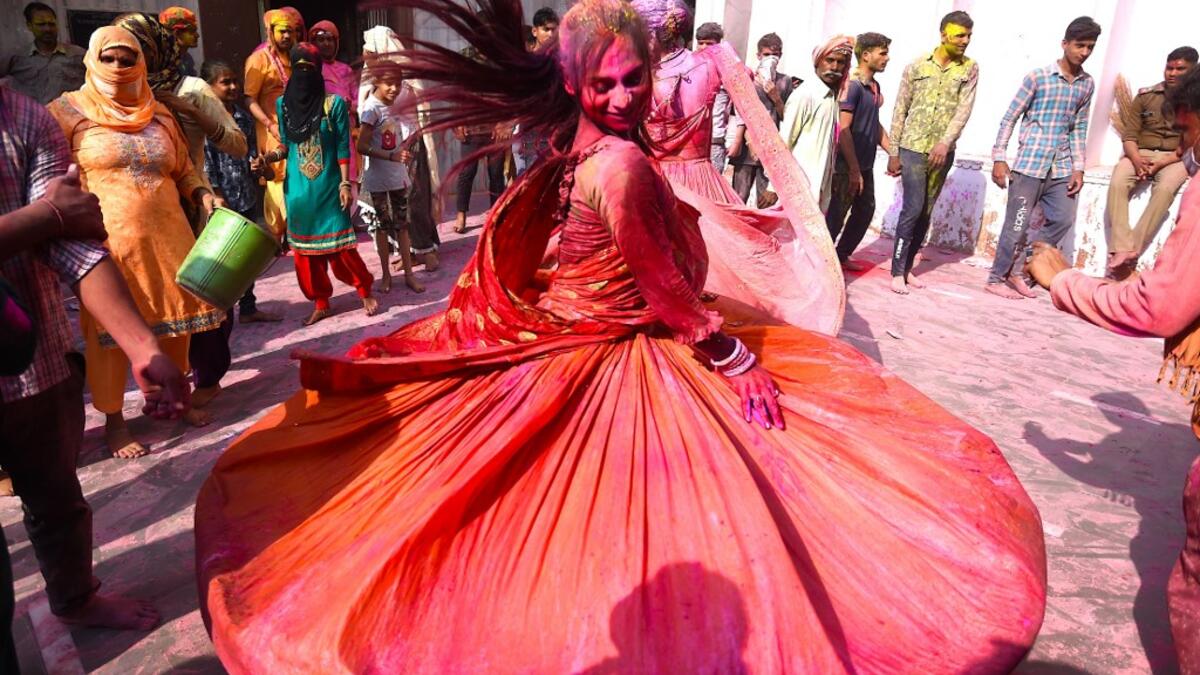 A Hindu devotee dances during Holi celebrations, the spring festival of colours, during a traditional gathering at a temple in Nandgaon village in Uttar Pradesh state on March 5, 2020. Holi is observed in India at the end of the winter season on the last full moon of the lunar month. Money SHARMA / AFP
