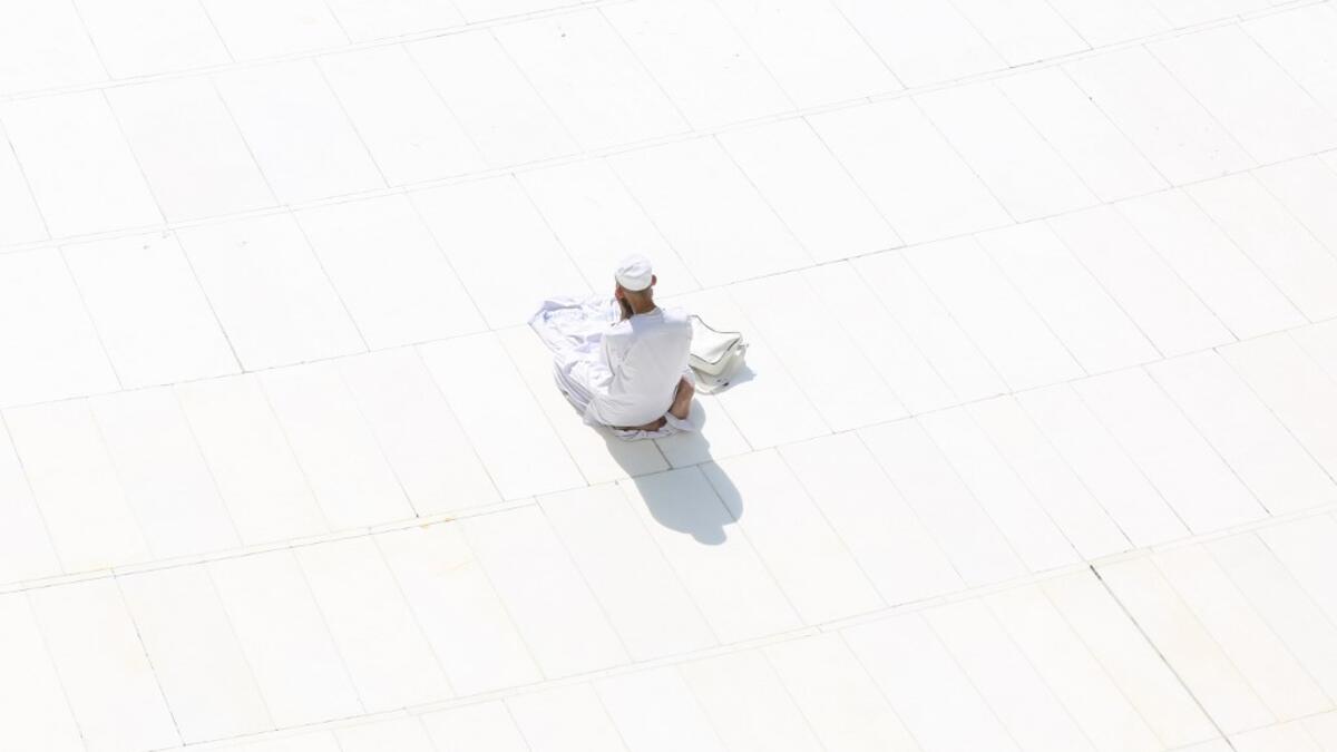 A Muslim worshipper prays near the sacred Kaaba in Mecca's Grand Mosque, Islam's holiest site, on March 7, 2020. Saudi Arabia reopened today the area around the sacred Kaaba, reversing one of a series of measures introduced to combat the coronavirus outbreak. Saudi authorities this week suspended the year-round umrah pilgrimage, during which worshippers circle the Kaaba seven times, and also announced the temporary closure of the area around the cube structure.  Abdel Ghani BASHIR / AFP