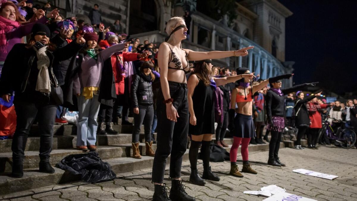 Women take part in a flashmob celebrating the International Women’s Day late on March 7, 2020 in Lausanne, western Switzerland. Fabrice COFFRINI / AFP