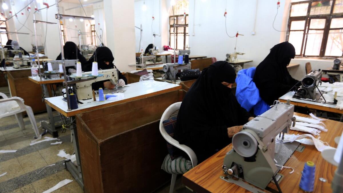 Yemeni women make face masks at a textile factory in the capital Sanaa on March 16, 2020. More than a decade after it shut down, 20 women have brought back to life Yemen's oldest industrial factory to manufacture what could save many lives amid a global pandemic: masks. Mohammed HUWAIS / AFP