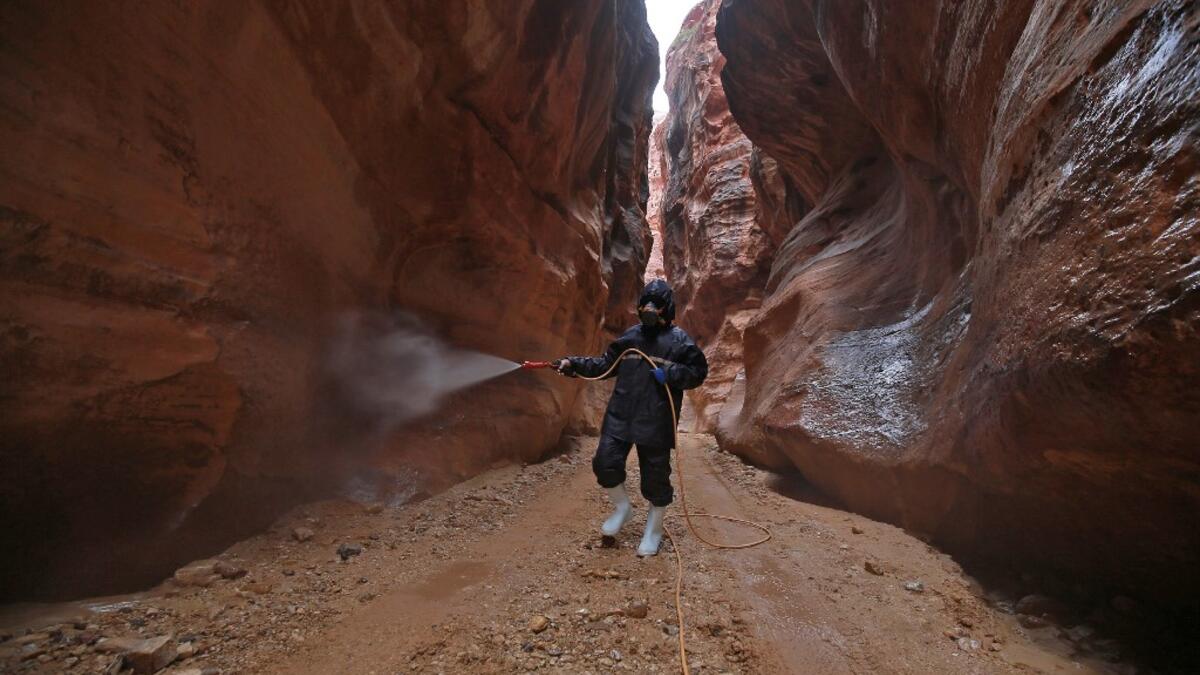 A labourer sprays disinfectant in Jordan's archaeological city of Petra south of the capital Amman on March 17, 2020, to prevent the spread of COVID-19. Khalil MAZRAAWI / afp