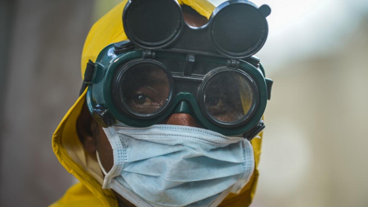 A cleaning staff waers protective gear to disinfect a metro carriage as a prevemtive measure against the spreading of the COVID-19 coronavirus in Addis Ababa, Ethiopia, on March 20, 2020. African countries have been among the last to be hit by the global COVID-19 coronavirus epidemic but as cases rise, many nations are now taking strict measures to block the deadly illness. Michael Tewelde / AFP