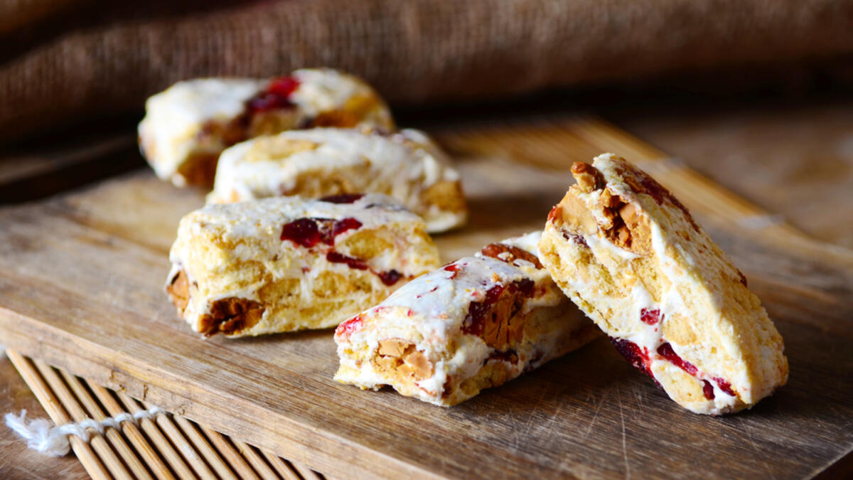 Homemade nougat bar with natural light on wooden plate on sackcloth background (Shutterstock)