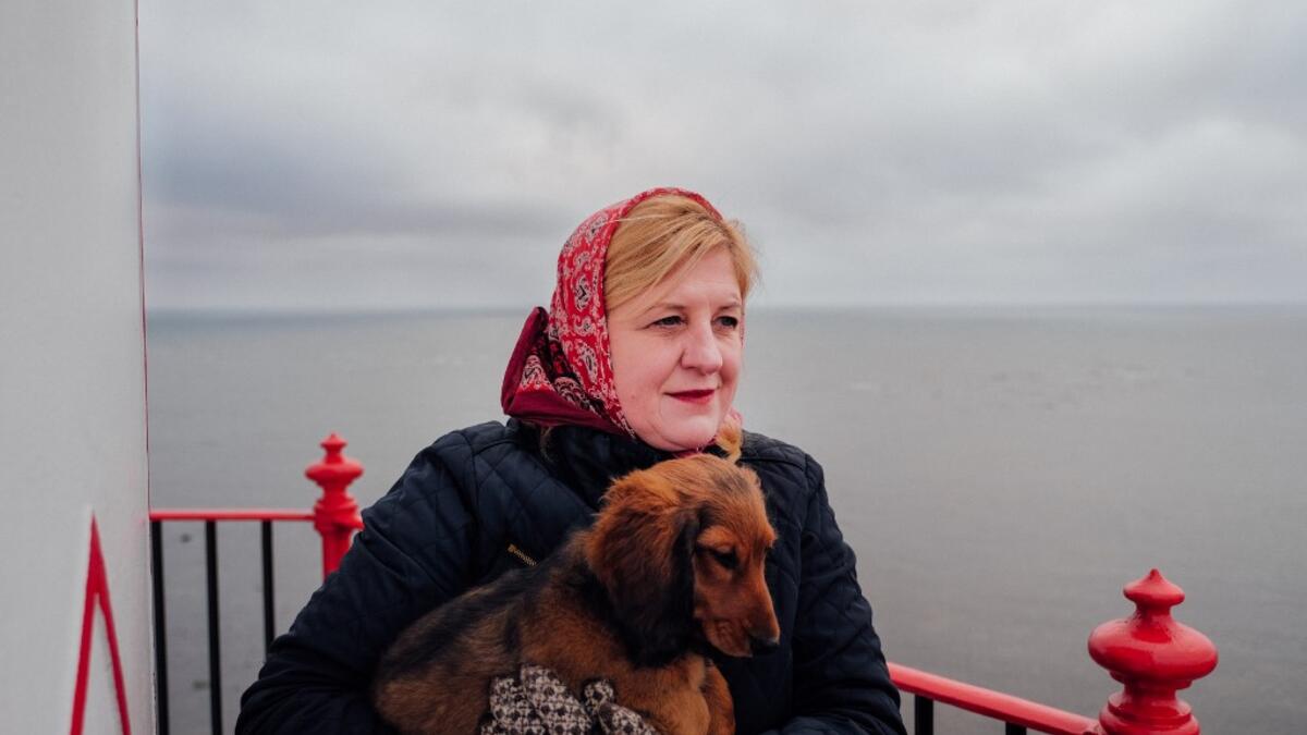 Elly Karjam, who is in charge of the lighthouse of the island, poses on November 20, 2019 on Kihnu island in the Baltic Sea, 10 kilometres (six miles) off the coast of Estonia. Steeped in folk traditions, Kihnu's historic way of life however is now threatened as economic hardship drives more and more islanders away in search of work. Alessandro RAMPAZZO / AFP