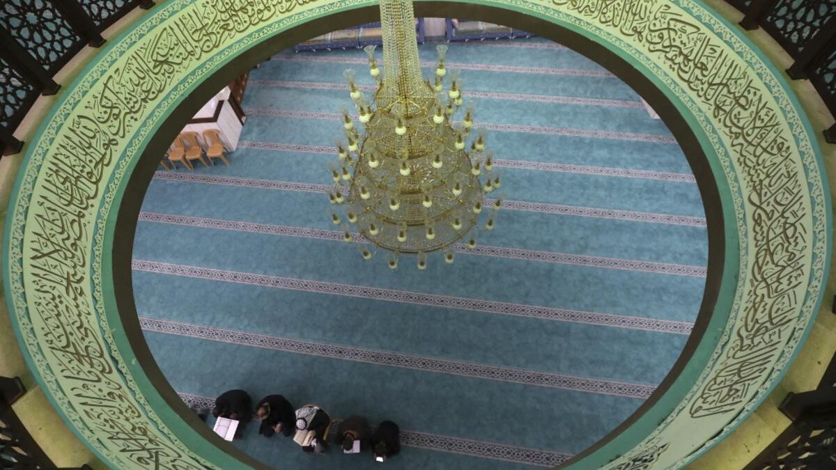 A few Palestinian worshippers pray at a mosque during the usually crowded weekly Friday prayers, in the midst of the coronavirus COVID-19 outbreak, in the West Bank town of Hebron on March 13, 2020. HAZEM BADER / AFP