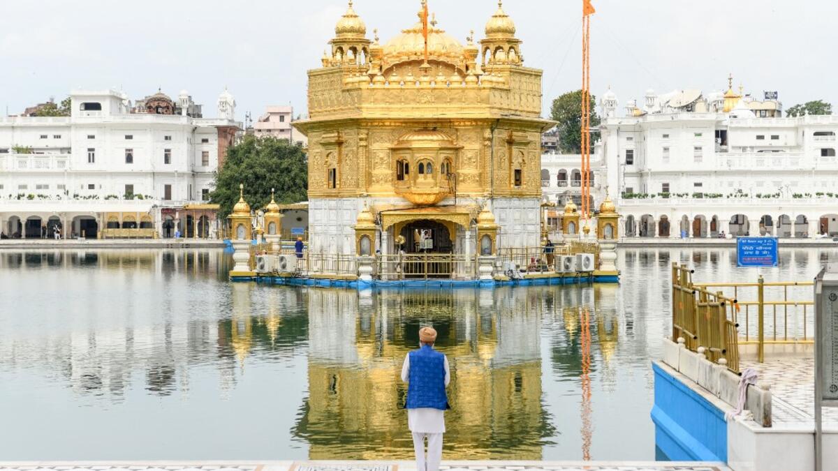A Sikh devotee pays respect at the deserted Golden Temple during the first day of a 21-day government-imposed nationwide lockdown as a preventive measure against the COVID-19 coronavirus, in Amritsar on March 25, 2020. NARINDER NANU / AFP