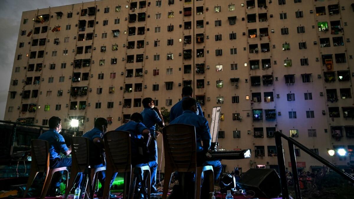 A music band formed by Sri Lankan Navy personnel plays outside a housing complex during a government-imposed nationwide lockdown as a preventive measure against the COVID-19 coronavirus, in Colombo on April 9, 2020. ISHARA S. KODIKARA / AFP