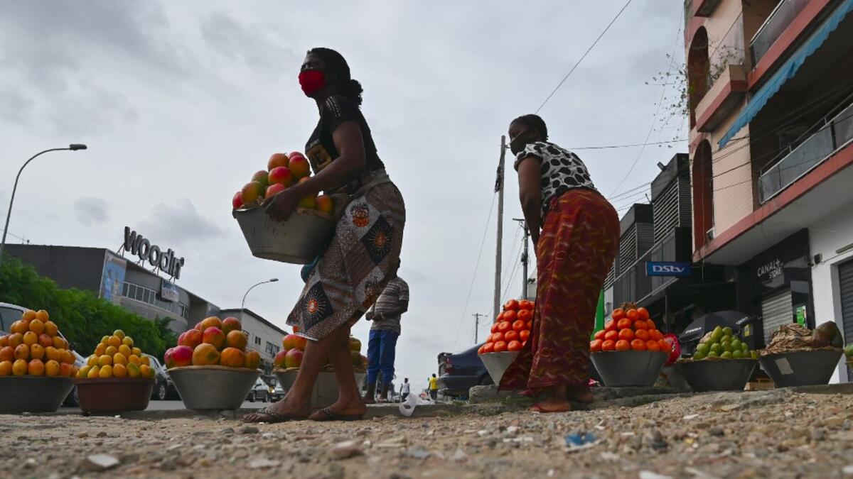 Street vendors sell fruits in a street in Abidjan on April 24, 2020 on the first day of Islamic Holy Month of Ramadan. ISSOUF SANOGO / AFP