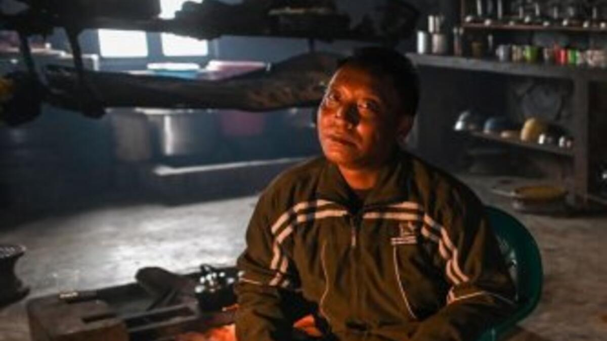 This photo taken on February 8, 2020 shows Tonyei Phawng, king of the Konyak tribe, talking to AFP during an interview inside his home in Longwa village in Myanmar's Sagaing region, near the border with India. The king of the Konyak tribe sleeps in Myanmar, but eats in India -- his house, village and people divided by a mountain border which serves as a vulnerable lifeline now severed by a coronavirus lockdown.  Ye Aung THU / AFP